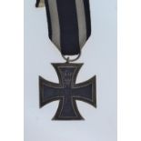 A WWI German Iron Cross, dated 1914 with black and white ribbon.