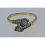 10ct gold crossover ring set with blue & clear stones, size N, 2 grams