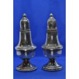 Pair of silver pepperettes, base marked 'Sterling weighted 925', weighted, gross weight 262 grams, h