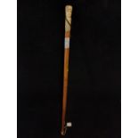 Antique walking stick with carved bone handle and white metal banding