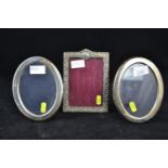 Three silver photo frames, including an oval-shaped pair, maker Francis Howard Ltd, Sheffield 1982,