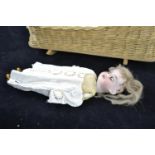 Antique baby doll, head marked '390 A10/OM Made in Germany', length 23 cms, in wicker cradle