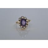 9ct gold ring bezel-set with a purple stone, size P, 3 grams