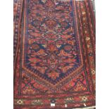 Hand woven wool wide runner rug, red ground with geometric design in navy. 280cm long x 105cm wide