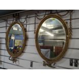 Pair of oval bevelled gilt framed Empire style mirrors, overall W43x H73cm