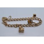 9ct gold charm bracelet with heart-shaped padlock clasp, with three charms, including church, di & c