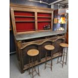 Slate topped rustic bar with slate top, shelf wall unit behind, & 3 bar stools,