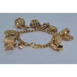 18ct gold charm bracelet suspending twelve 9ct gold charms, all charms stamped '9.375' except Scorpi