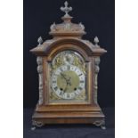 Ornate mantle clock with 2 dials ,gilt decoration around the face, with key and pendulum. Ht 48.5cms