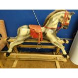 Dapple grey rocking horse with red saddle on pine swing base