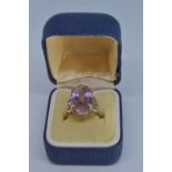 9ct gold ring claw-set with an oval amethyst 20 x 12mm, size N/O, gross weight 5.3 grams
