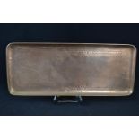 A Newlyn copper rectangular tray with planished and chased detail depicting St Michael's Mount and a