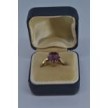 9ct gold ring with single purple stone, size N/O, gross weight 1.9 grams