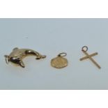 Three 9ct gold pendants, including: a dolphin, length including bale approx. 38mm; cross & St. Chris