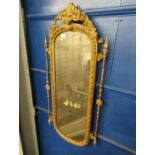 Ornate gilt framed pier mirror. Mirror is silvered with age. H106 x W48cm
