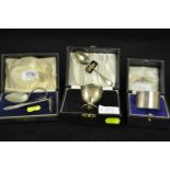 Three boxed silver christening sets, various makers & dates, including a napkin ring with initials '