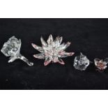 Four Swarovski flowers, including: Lotus Flower, no. 5100663, A9100NR000001; Desert Rose gist, no. 5