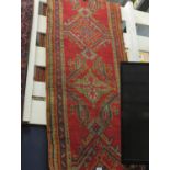 Handmade wool carpet runner. Red ground with blue & green. 70cm x 250cm