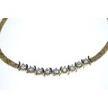 18ct gold necklace set with nine diamonds on fancy link chain, circumference 460mm, gross weight 20