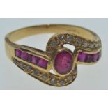 18ct gold, ruby & diamond crossover ring, the central bezel-set ruby measuring approximately 5.5 x 4