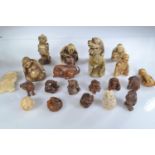A collection of wooden ojime beads, netsuke and other carvings in wood and bone, 21 in total