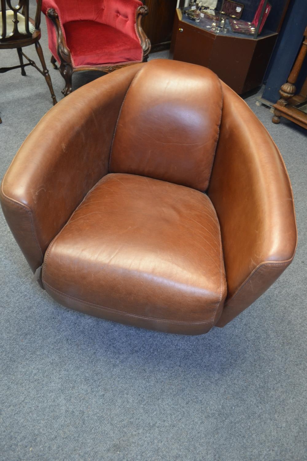 Mid Century style tan leather swivel tub chair