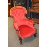 Walnut Victorian (circa 1880) spoon back armchair, button backed and upholstered in raspberry velvet