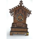 Late C19 Black Forest style oak cased cuckoo bracket clock with ebonised trim. H62.5cm W39cm D21cm