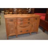 Pale mahogany carved fronted sideboard, with six drawers over two cupboards. 152cm x 55cm x 94cm.