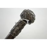 1925 white metal topped walking cane depicting dragons, fish and crab,  initialed G.E.J., length 92.