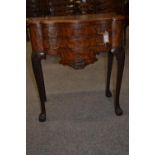 Flame mahogany serpentine fronted three drawer chest of drawers, with ball and claw feet. Width 66cm