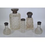 Five silver topped glass inc. three bottles and a pair of pepperettes