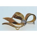 18ct gold bow brooch set with diamonds, with white gold pin, length 42mm, gross weight 6.9 grams