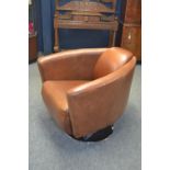 Mid Century style tan leather swivel tub chair