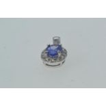 18ct white gold cluster pendant set with diamonds surrounding a central blue stone, possibly kyanite