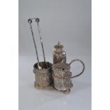 Chinese white metal cruet set, the pepperette, salt & mustard with embossed panels of bamboo & bloss