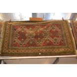 Floral geometric patterned rug with triple central medallion in tones of red, green and cream, 2m x