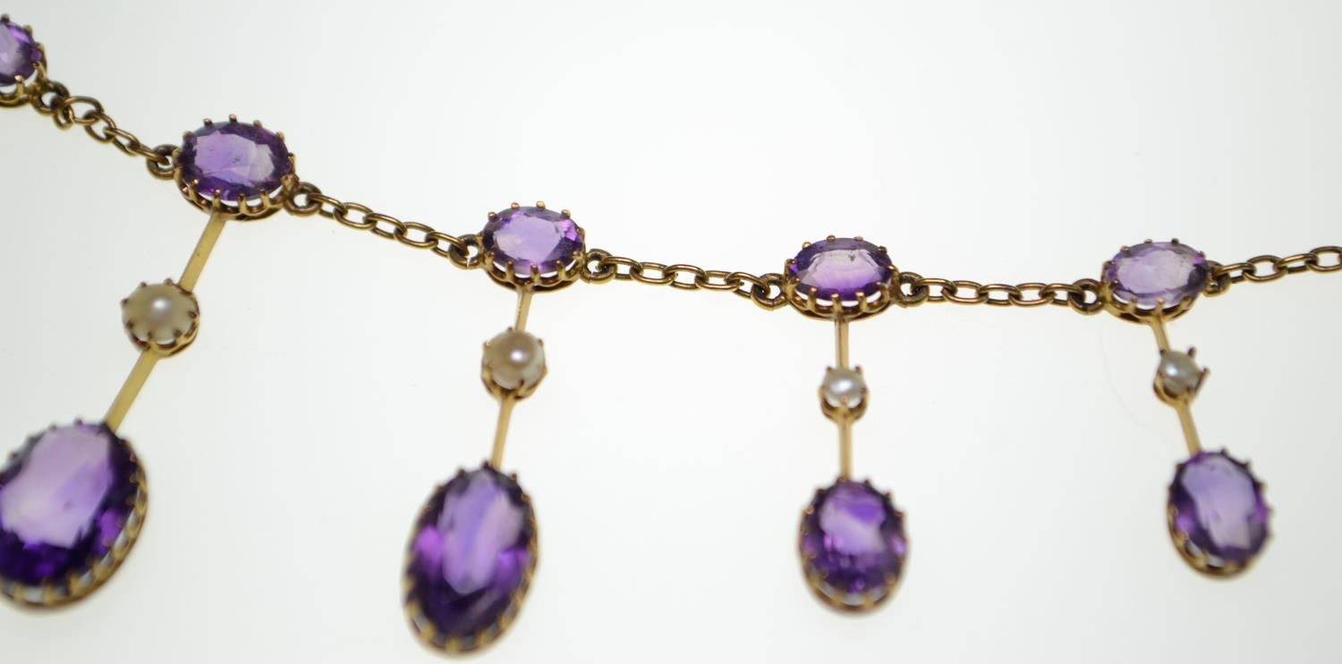 An Edwardian amethyst and half pearl gold fringe necklace, comprising graduating claw-set oval-cut a - Image 6 of 8