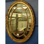 Gilt framed oval mirror with mirrored border, 67.5 x 53cm