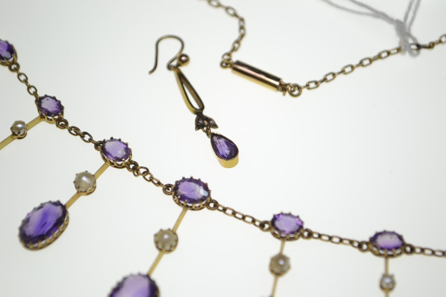 An Edwardian amethyst and half pearl gold fringe necklace, comprising graduating claw-set oval-cut a - Image 8 of 8