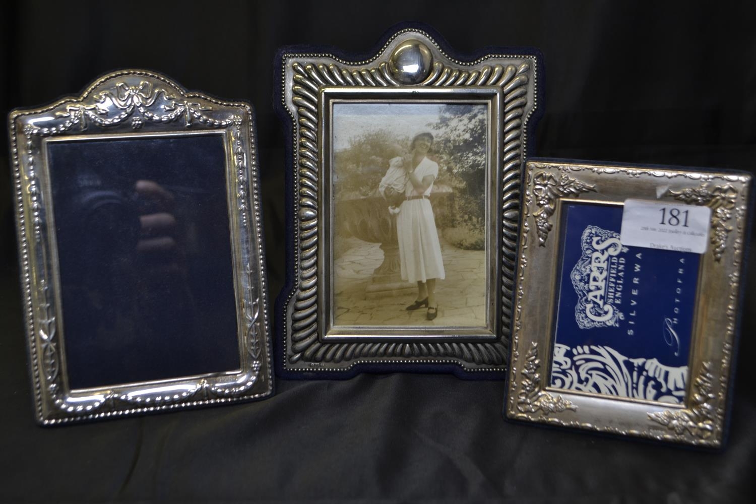 Three silver photo frames, largest marked T.S LTD with lion, the other two hallmarked for Carr's of 