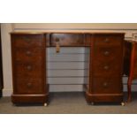Mahogany nine drawer knee hole desk on castors, with leather top and drop handles. Width 119cm x dep