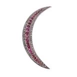 A DIAMOND AND RUBY CRESCENT BROOCH