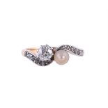 AN EARLY 20TH CENTURY DIAMOND AND PEARL TOI ET MOI RING