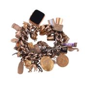 A MID 20TH CENTURY 9 CARAT GOLD CHARM BRACELET