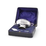 A SILVER TWIN HANDLED CHRISTENING BOWL AND SPOON, BARKER BROTHERS SILVER LTD