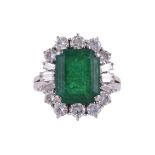 AN EMERALD AND DIAMOND CLUSTER RING