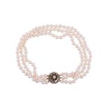 A THREE ROW CULTURED PEARL NECKLACE TO A SAPPHIRE AND CULTURED PEARL CLASP