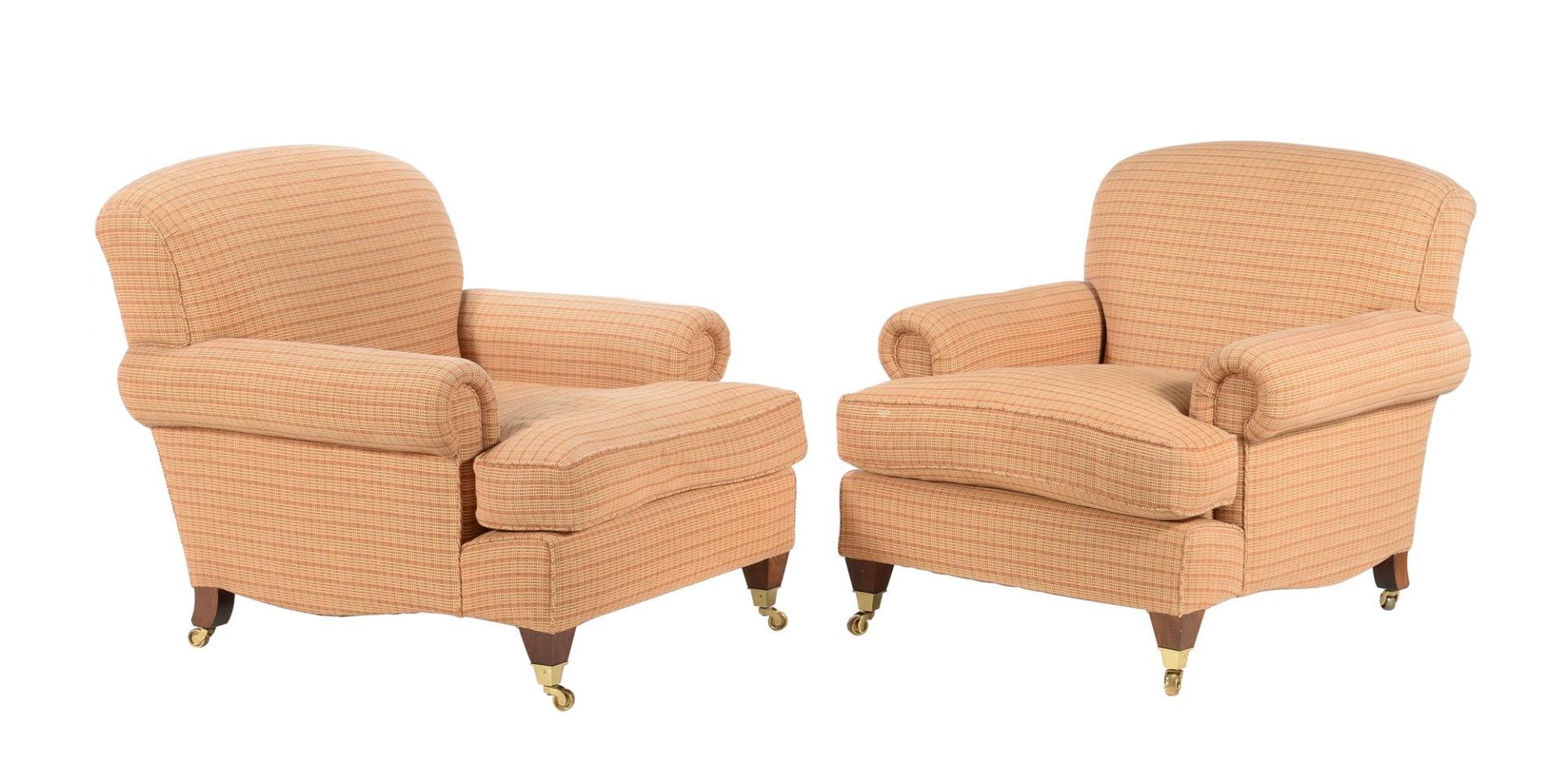 A pair of upholstered armchairs in the manner of George Smith