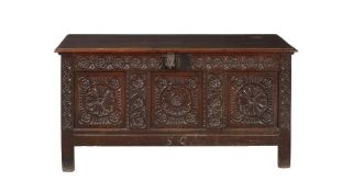 A carved oak three panelled coffer